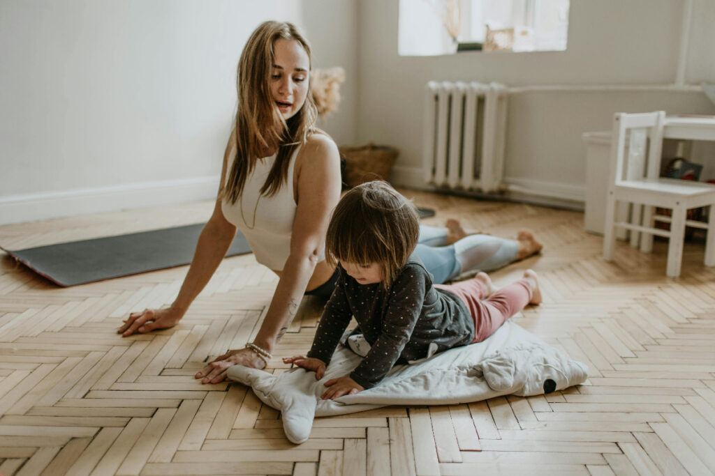 Mother and daughter in yoga pose.